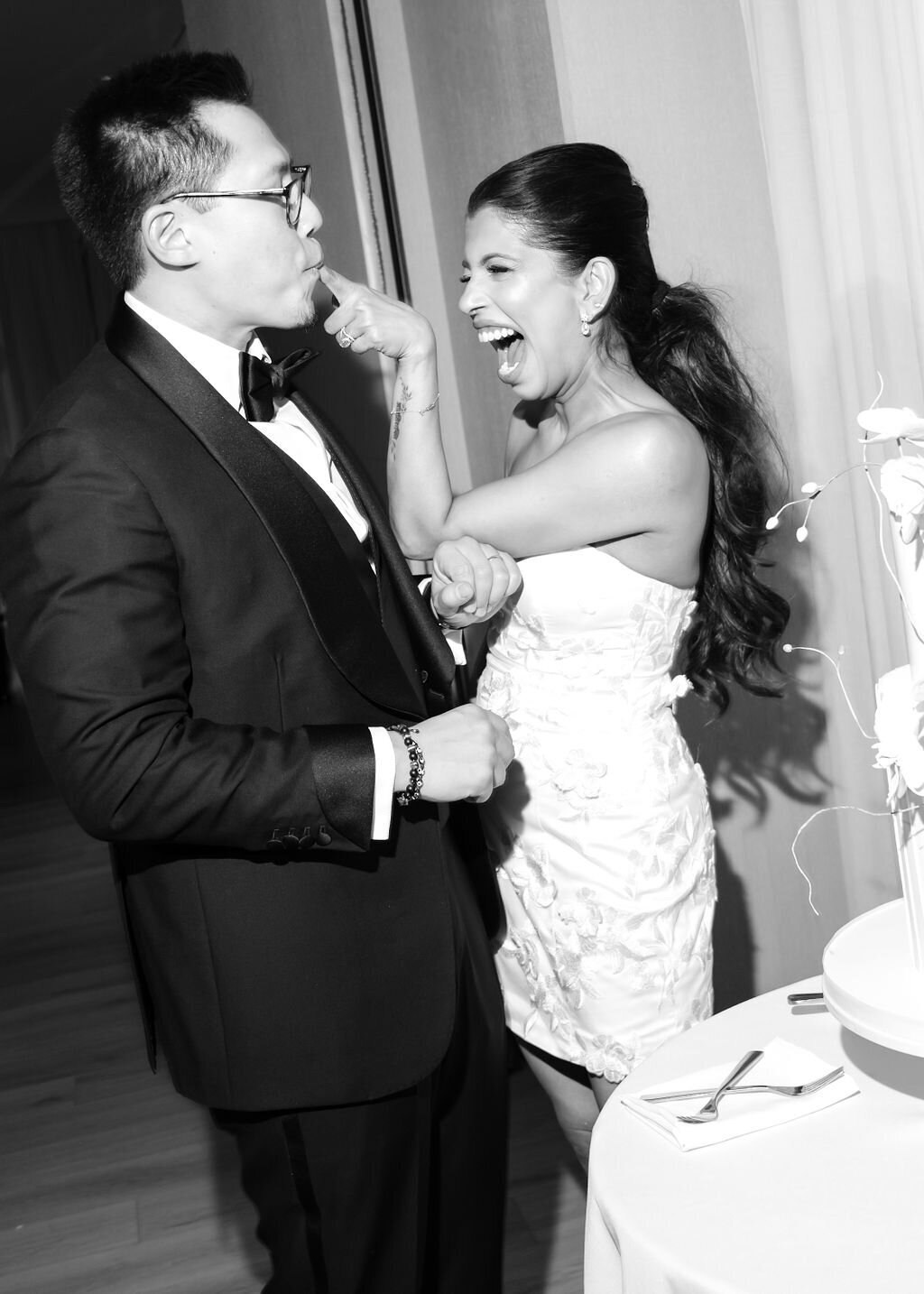 Bride and groom feeding each other Daniel Colonel wedding cake at Public Hotel in NYC