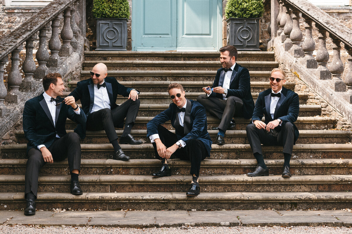 Groomsmen on steps at Kingston Estate in South Devon 