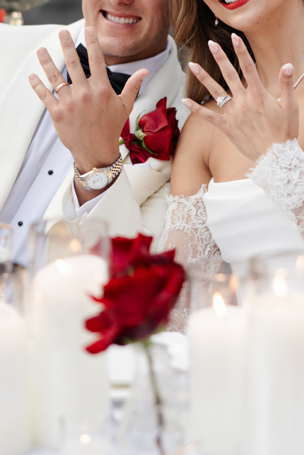 Close up bride and groom wedding ring red flowers