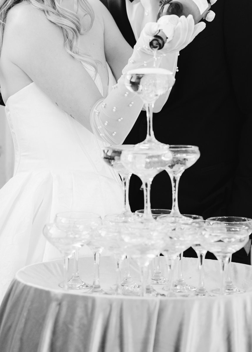 black and white wedding champagne tower pour