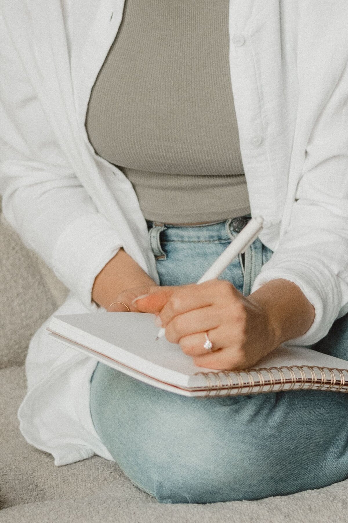 Close-up of Vickie of VERVE & COLOR taking notes during a client meeting, focusing on creative strategy and design details.