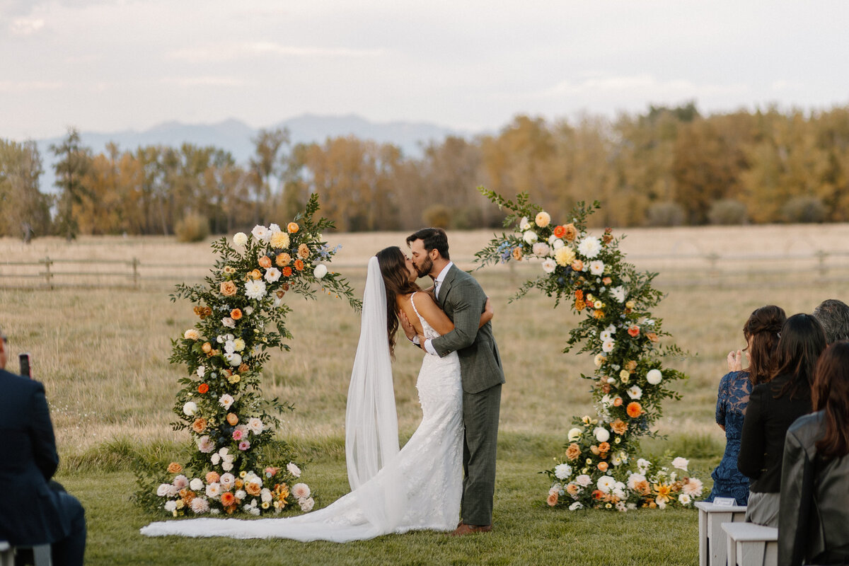 newlyweds kissing at wedding ceremony