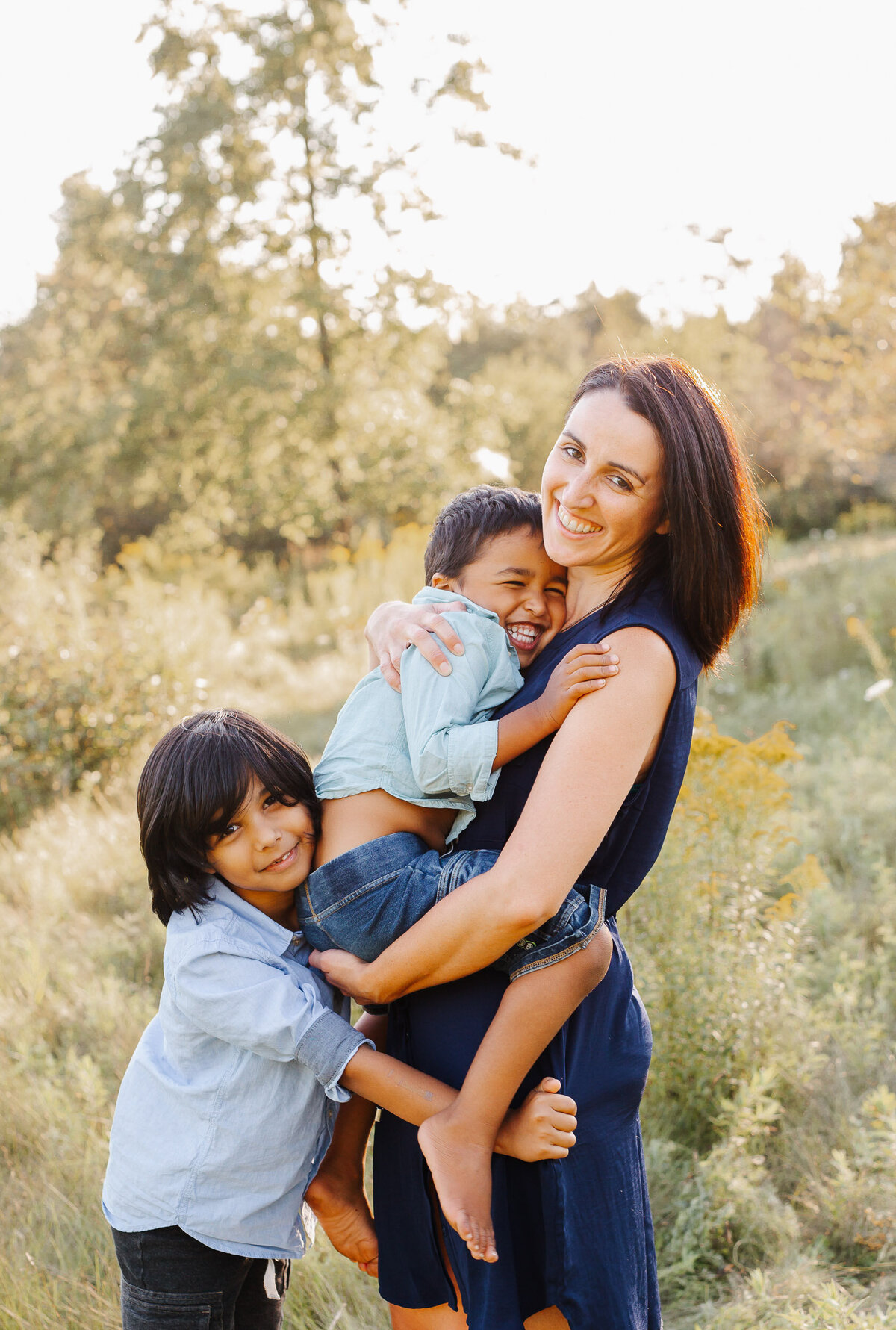 Two children embrace Mom during their photoshoot with Chelsey Kae Photography.