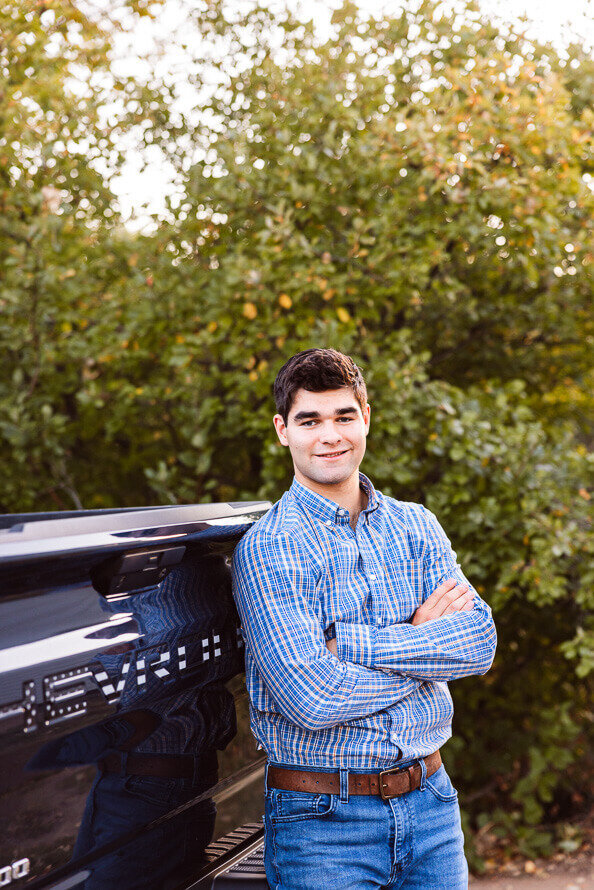Boy leans on his Chevy truck for photo session.