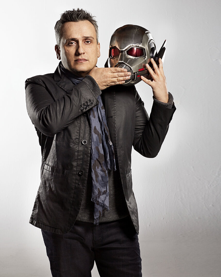Portrait of Joe Russo holding a film reel with a dynamic expression, photographed by Ylva Erevall.