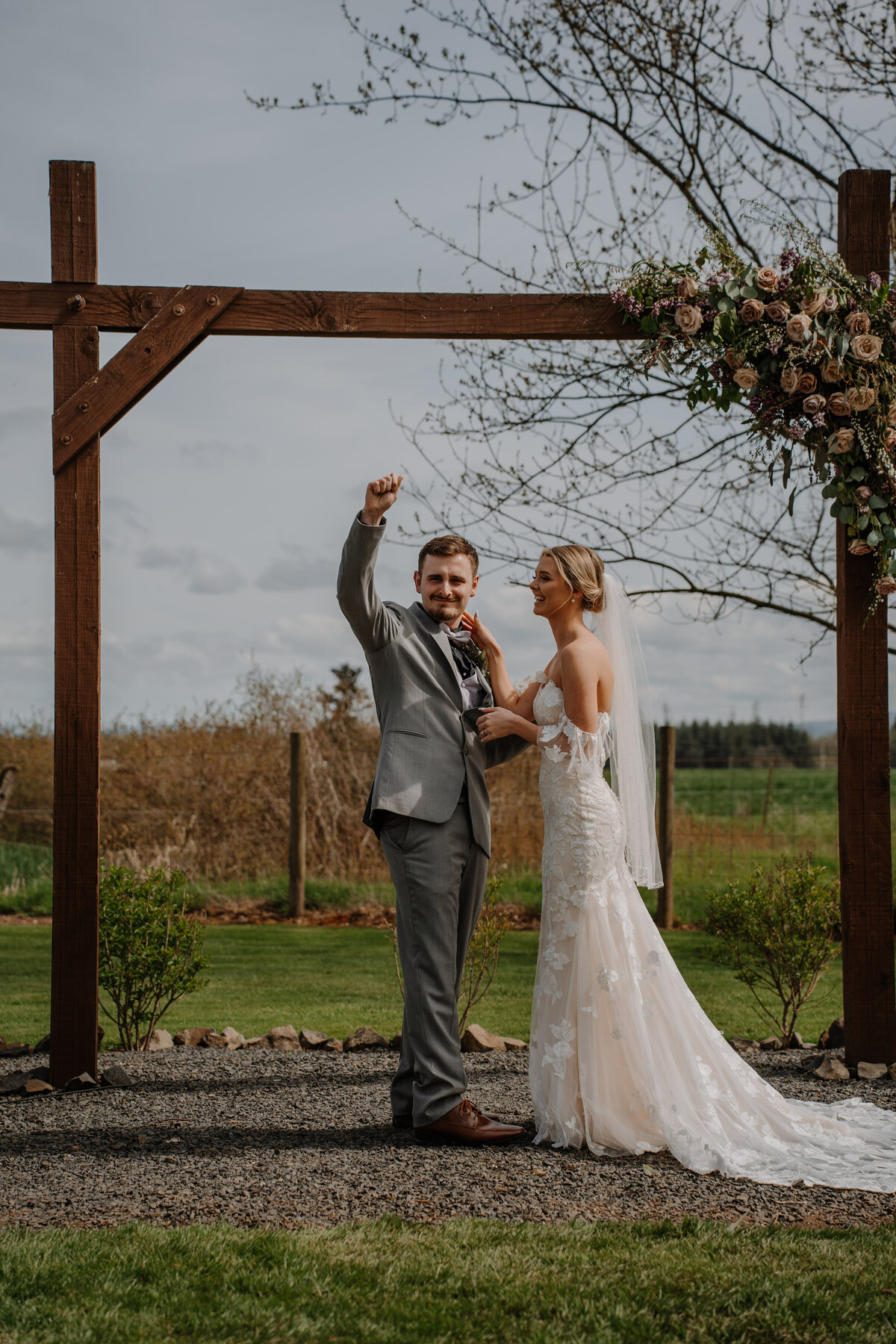 Groom holding up fist with bride