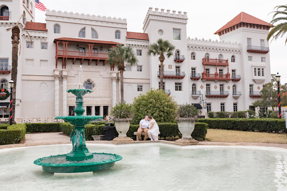 LGBTQ couple sitting in front of water fountain at Lightner Museum in St Augustine Florida by St Augustine wedding photographer