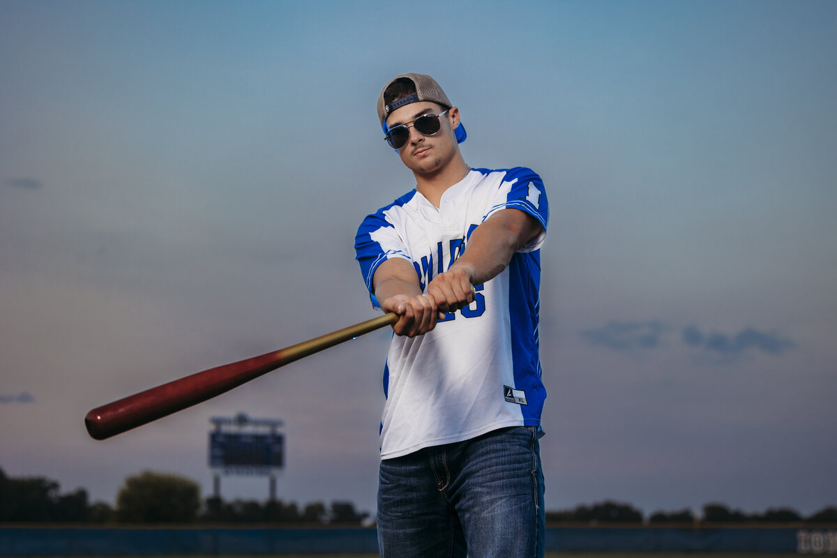 Ionia baseball player posing fo sport photos for high schoolers.