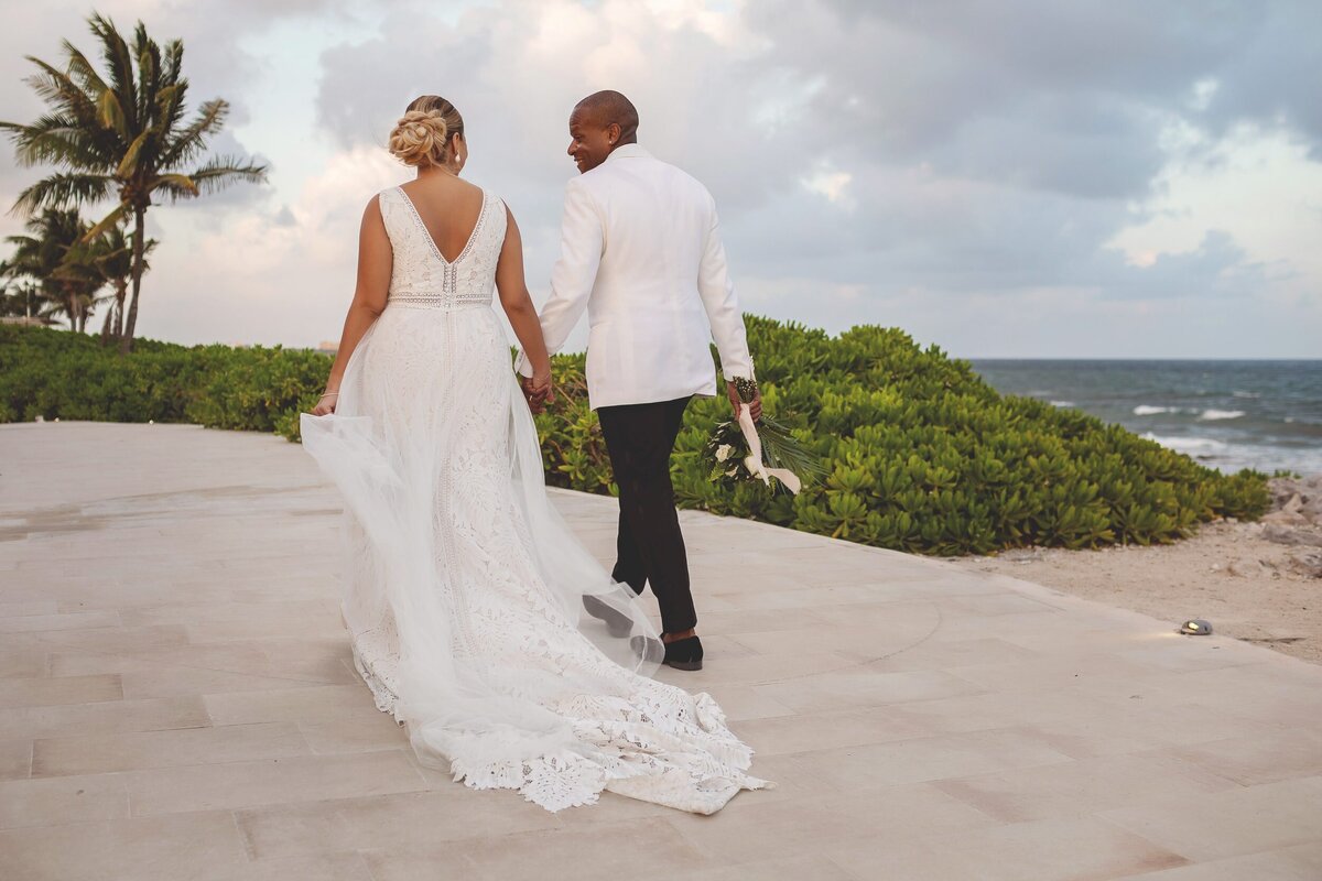 Bride and groom walking away at wedding in Riviera Maya