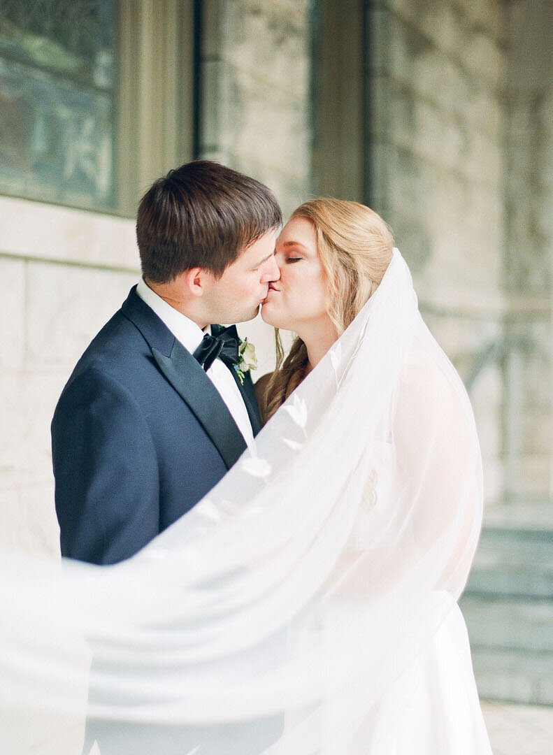 Bride and Groom Kissing at the Church Photo