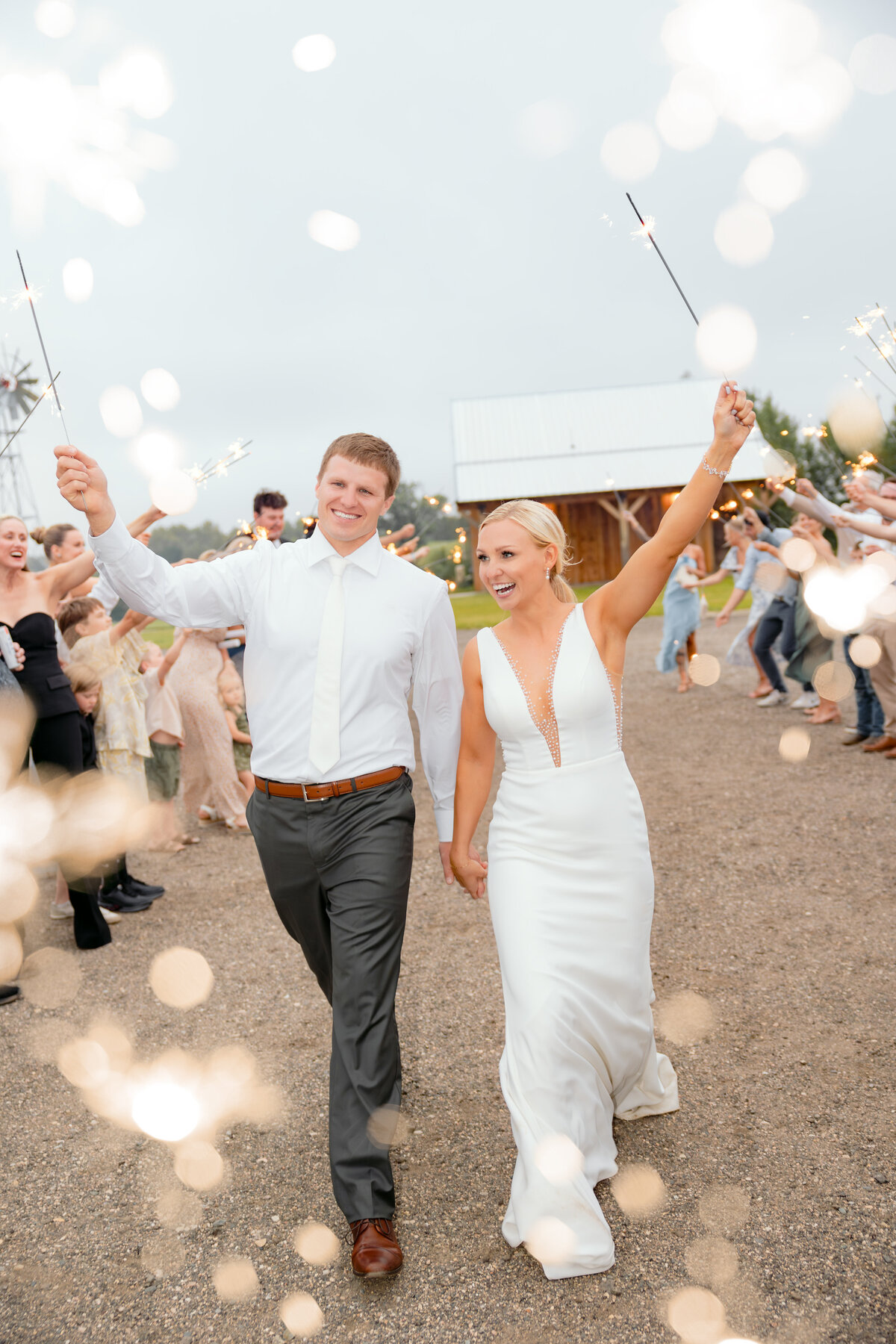 Bride and groom enjoy a sparkler exit at The Lake Elsie Wedding Barn in Hankinson, North Dakota.