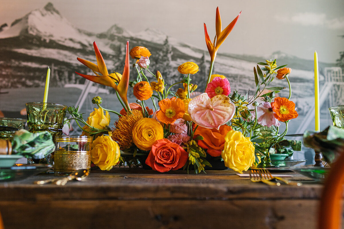 Bright arrangement of tropical flowers in coral, orange and yellow at Campfire Hotel in Bend Oregon