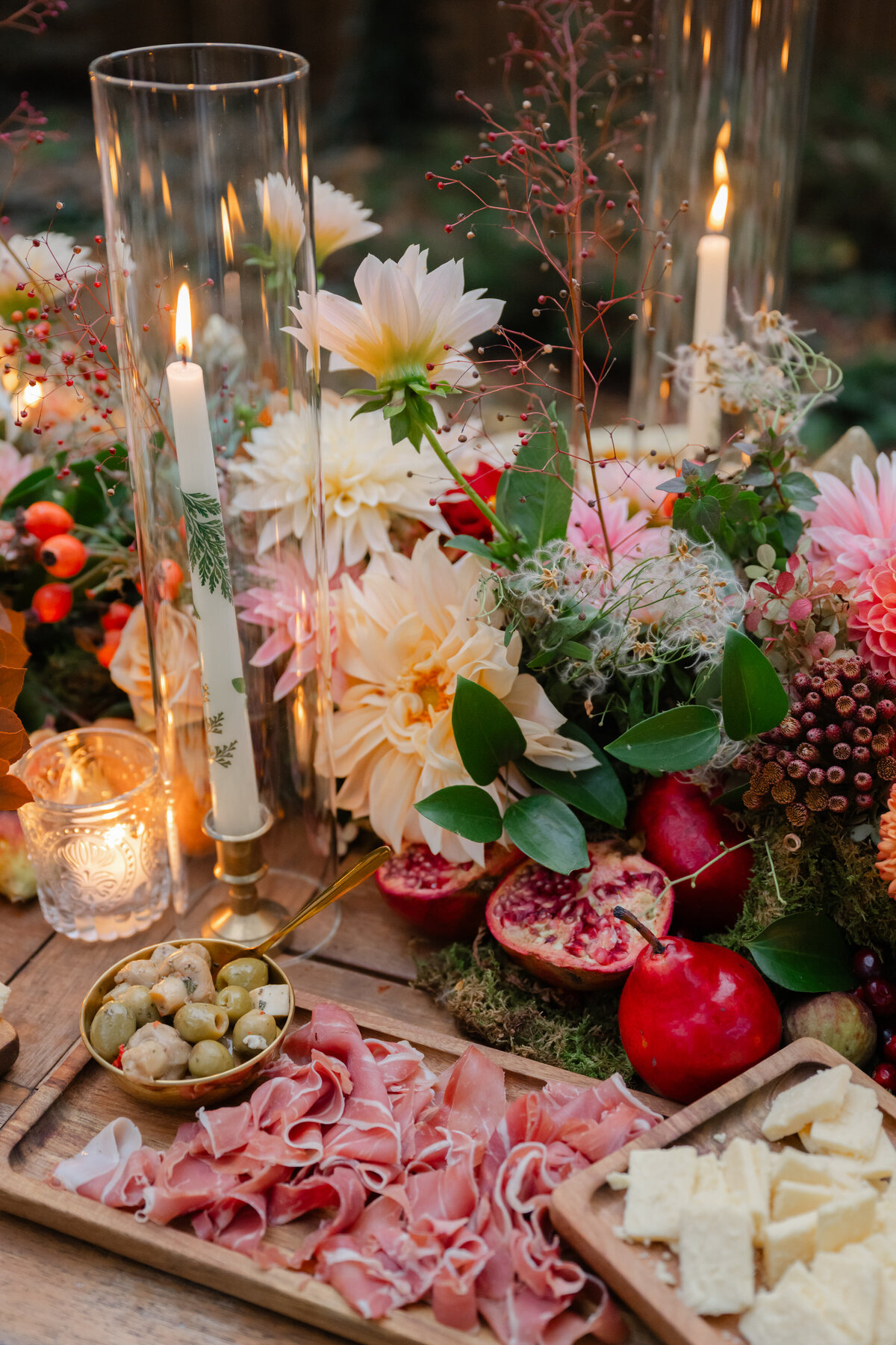 Charcuterie surrounded by flower arrangement