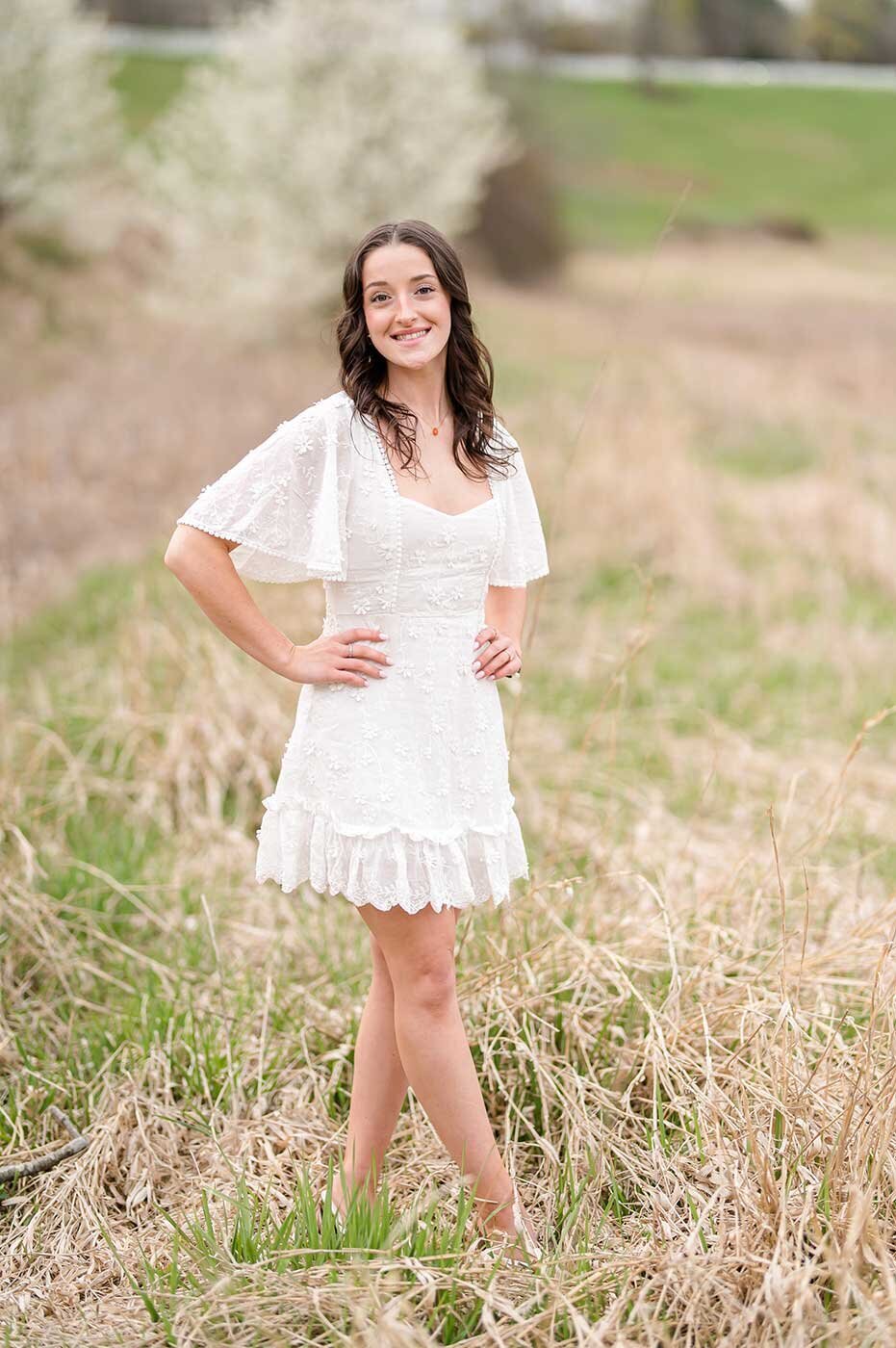 Young woman in white dress in country field