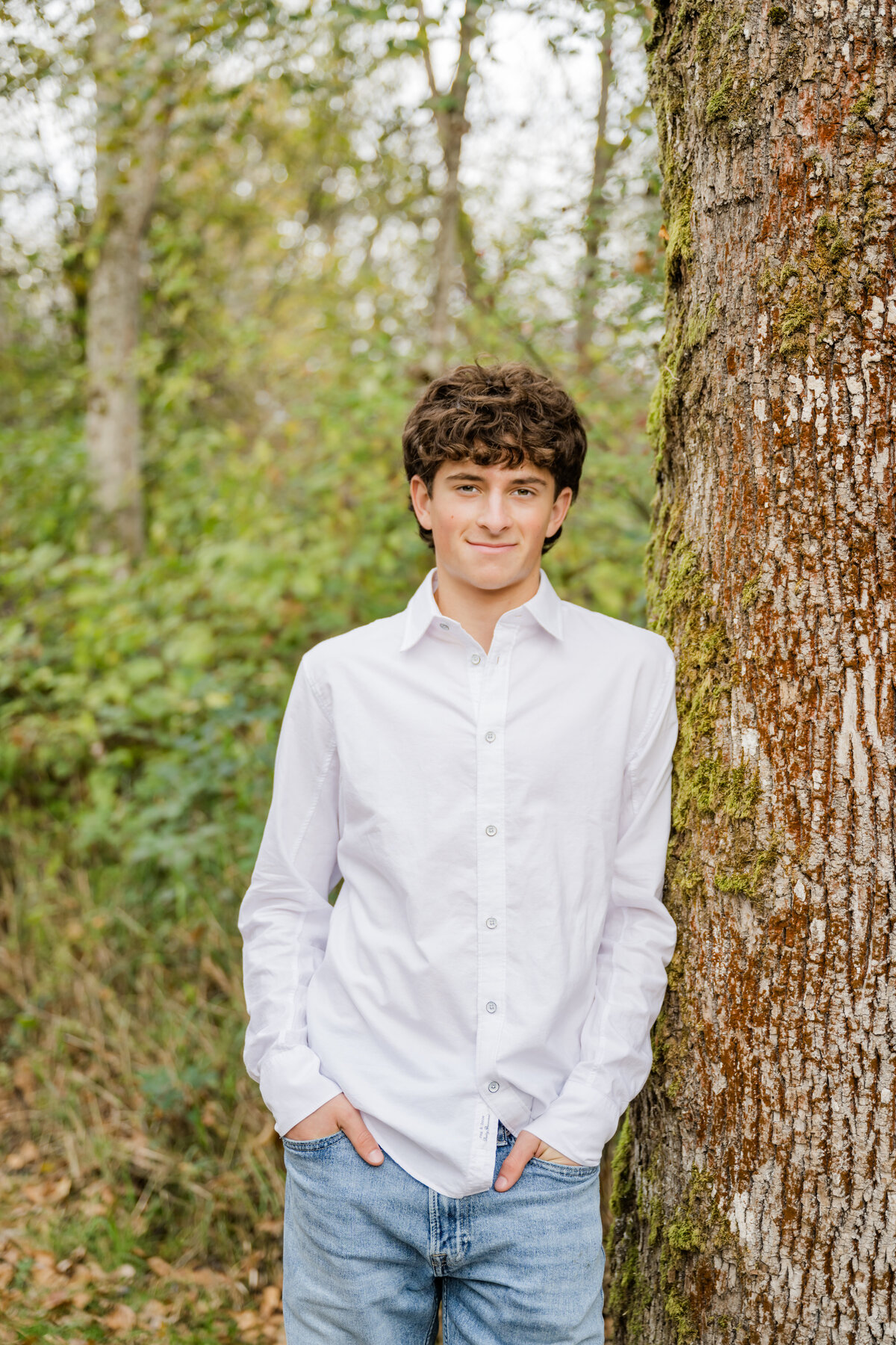 senior guy leaning on tree