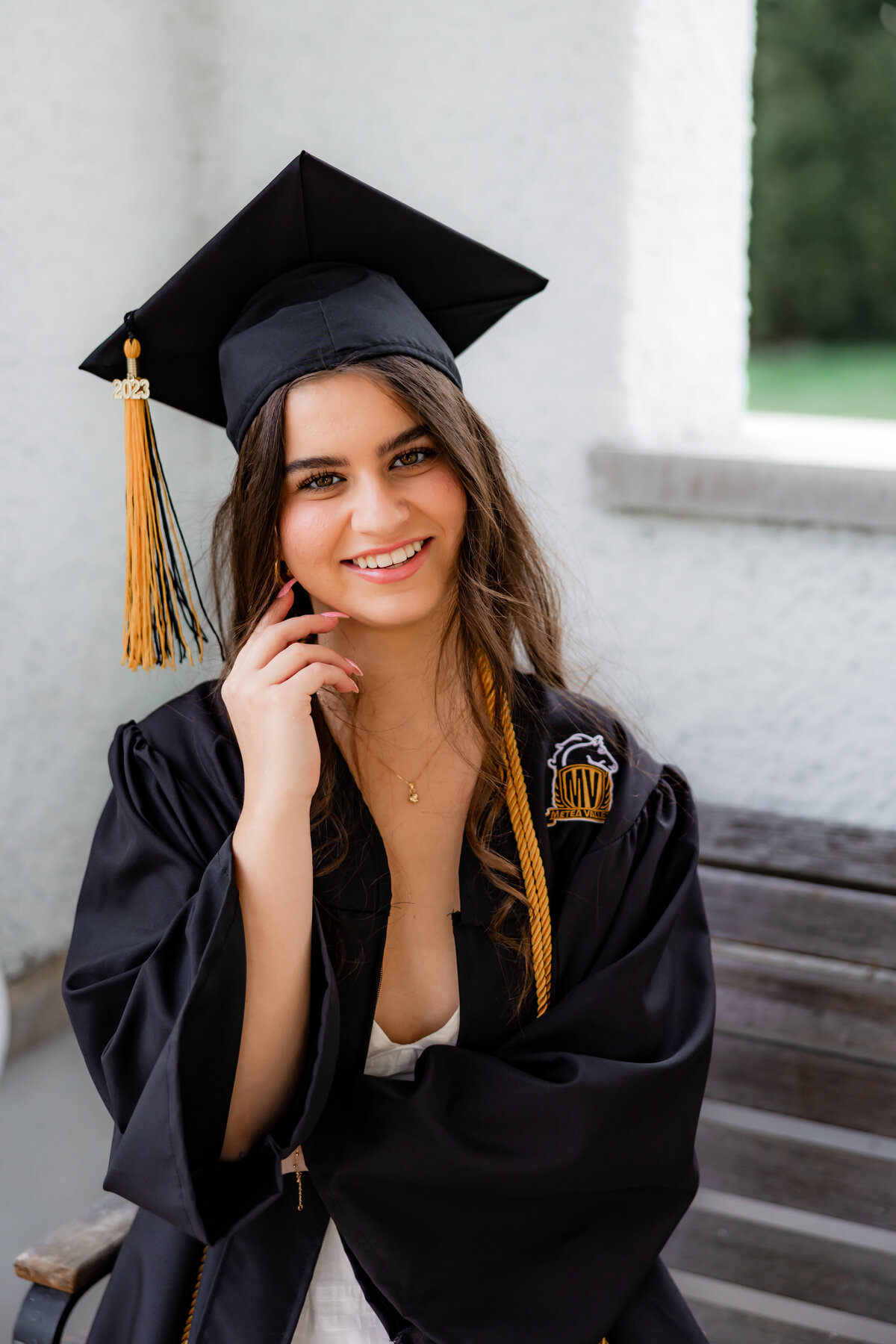 A portrait of a graduate in her cap and gown.