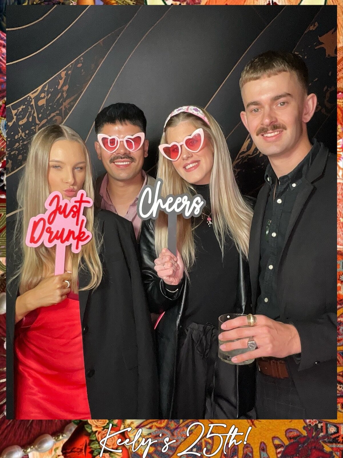 four people pose with colourful photo booth props at a 50th birthday in christchurch