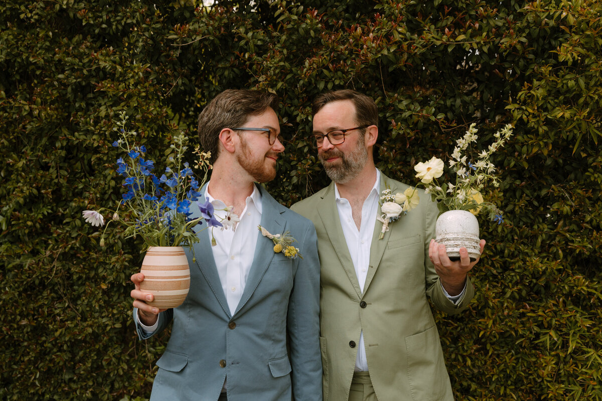grooms holding llowers