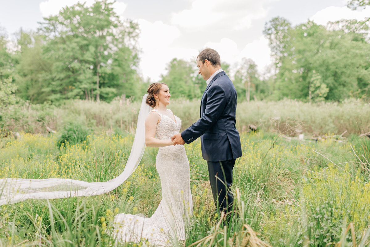 bride and groom dancing in a field