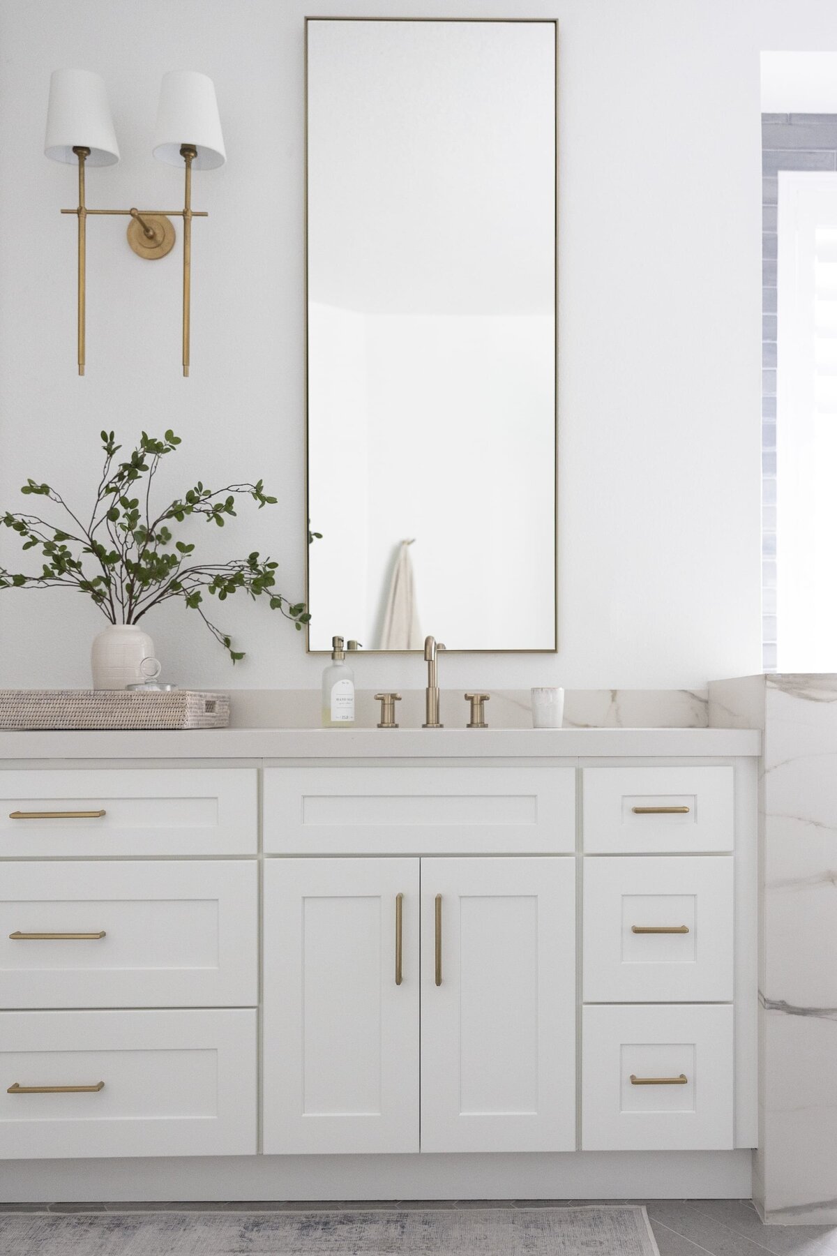dewine design orlando interior designer contemporary coastal primary bathroom white cabinets with gold hardware