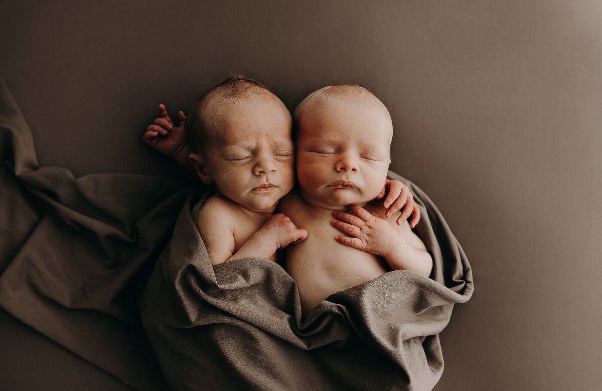 Serene portrait of newborn twin babies nestled closely together in Mullingar, Ireland.