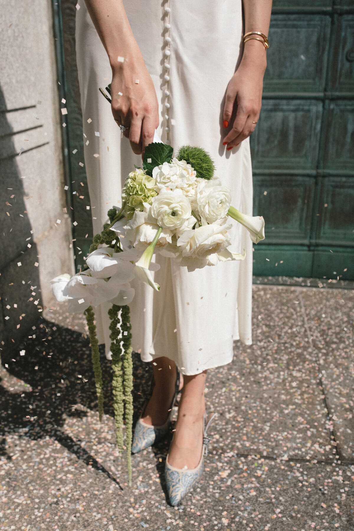 nyc city hall elopement bride with vintage dress white bouquet blue jadior heels and confetti