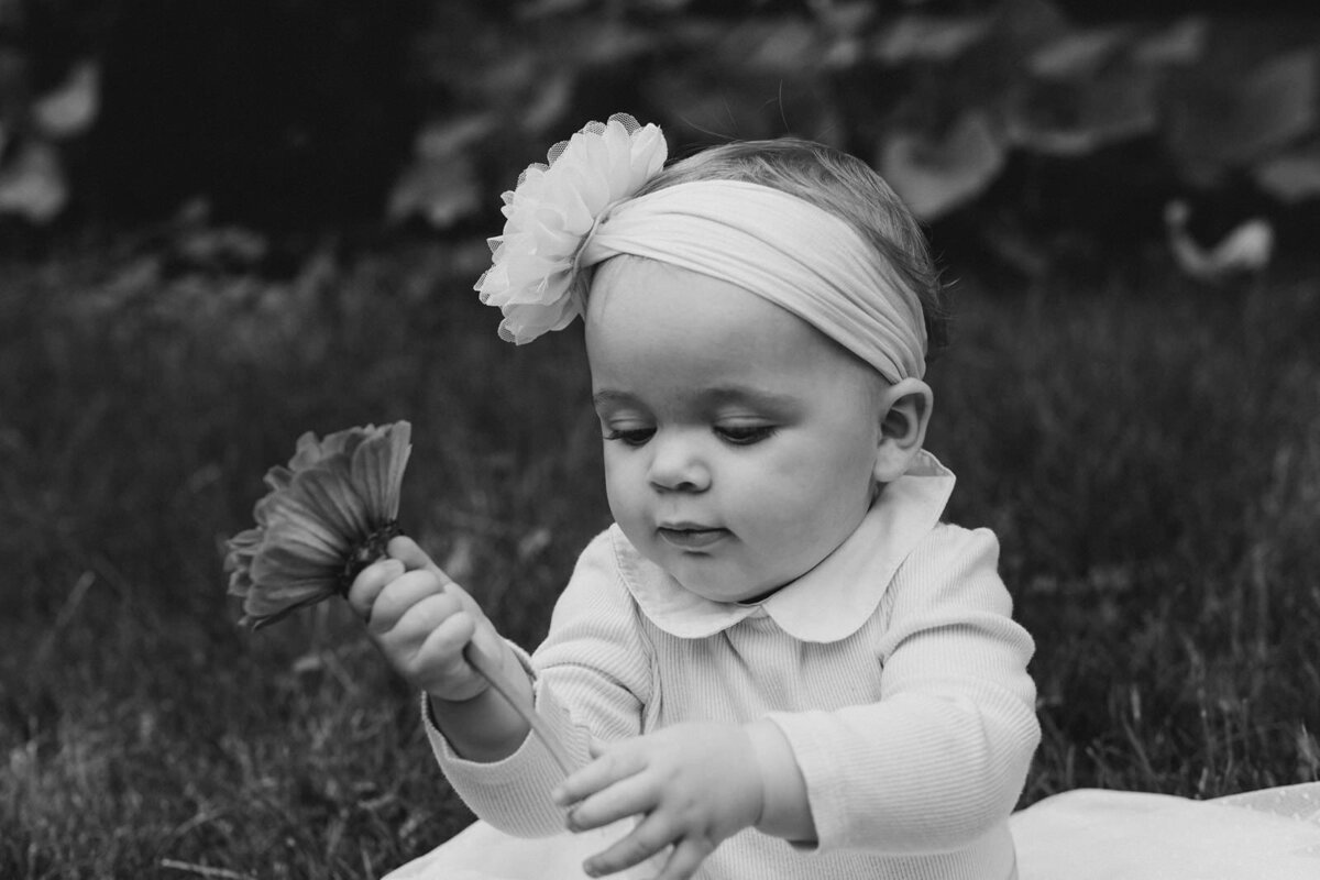 military child plays with flower