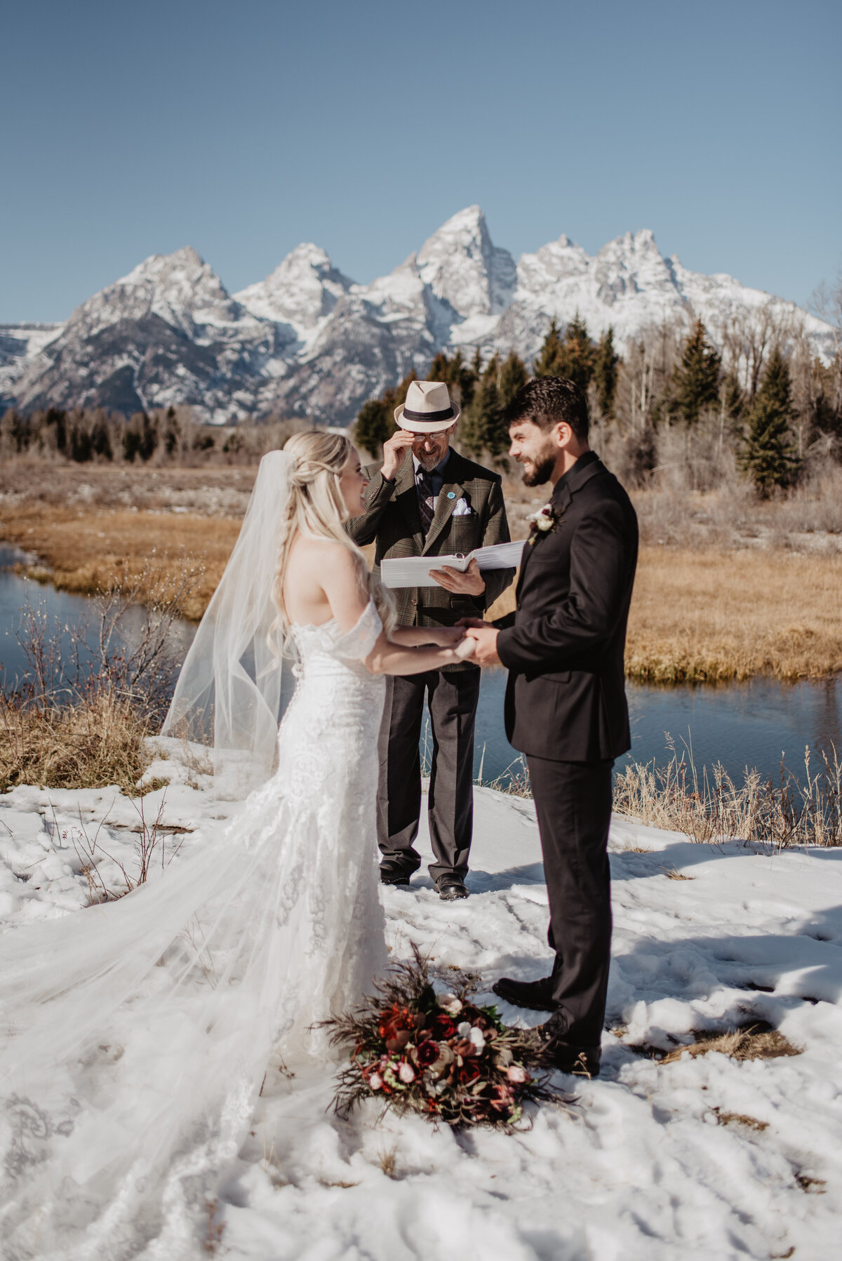 Jackson Hole Photographers capture couple with officiant during winter elopement