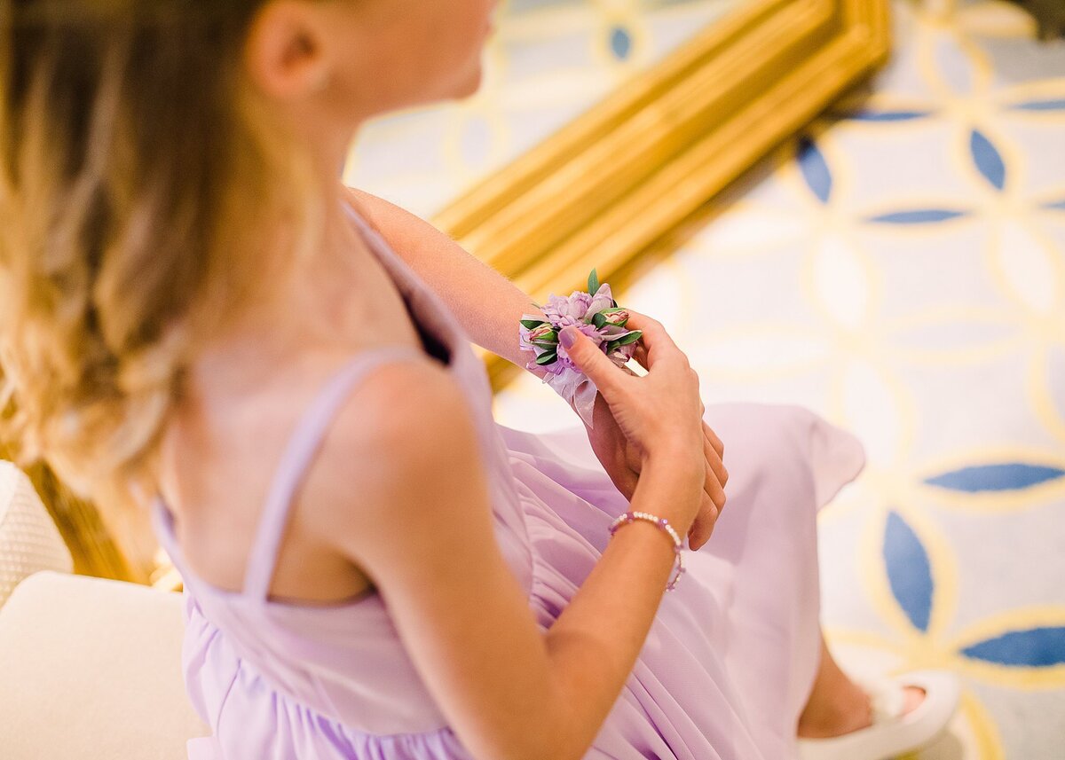 bridesmaid plays with corsage at Disney Wedding Pavilion