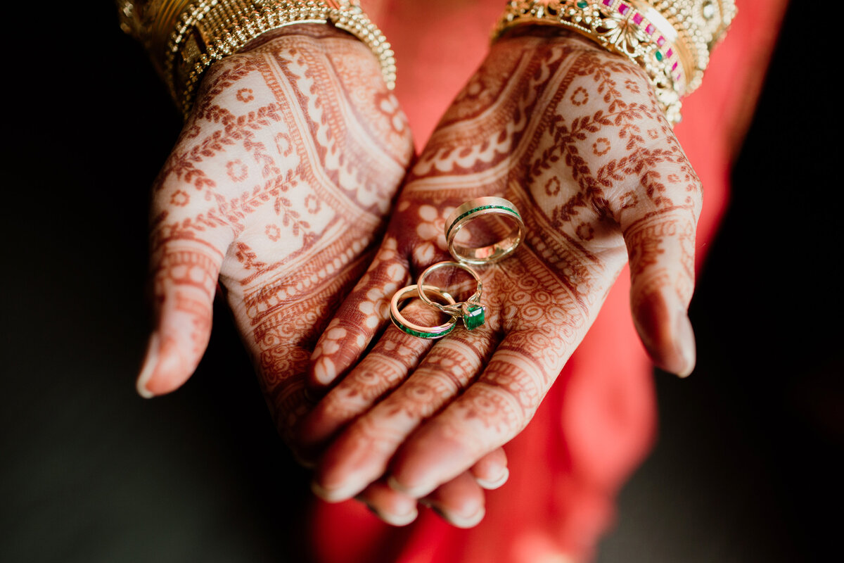 Indian bride showcasing her Henna hand tattoos and emerald rings captured by Fort Worth Wedding Photographer, Megan Christine Studio