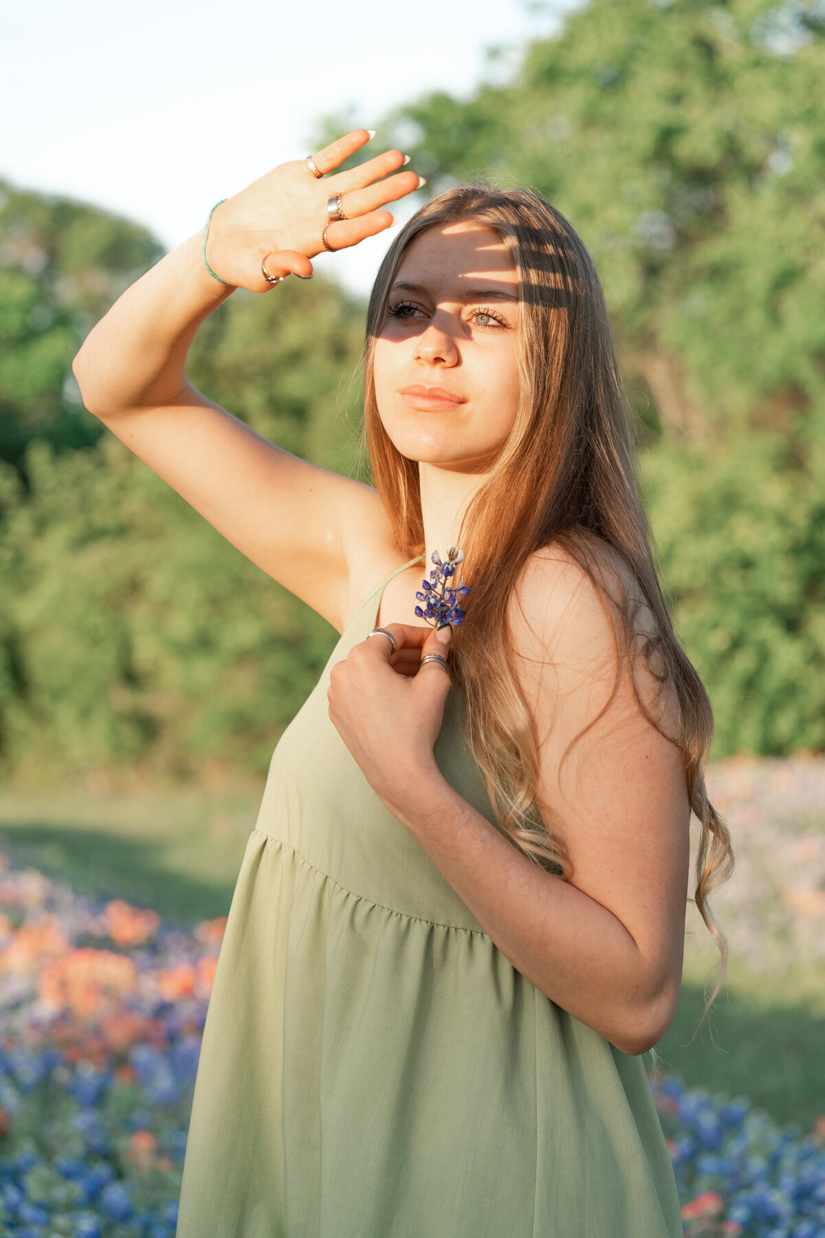 High school girl with dress in the wildflowers for senior photos. In Austin Texas.