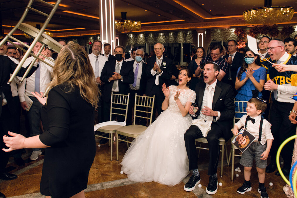 A bride and groom reacting to dancing at a wedding.