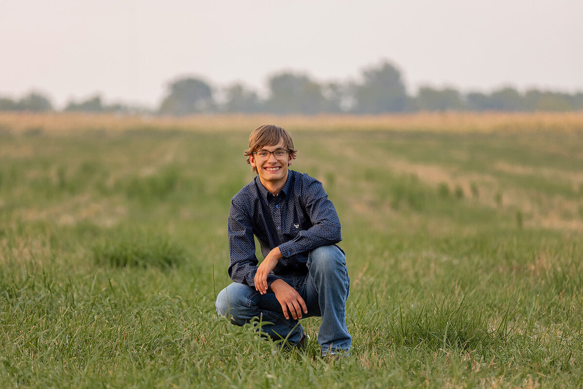 male senior in field smiling