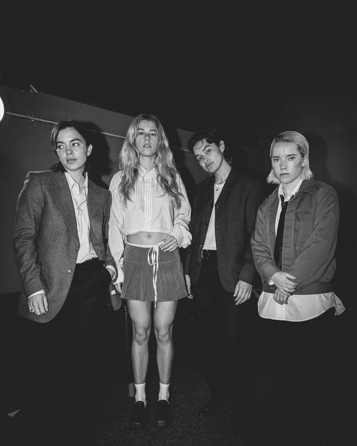 The aces stood side by side each holding different subtle poses