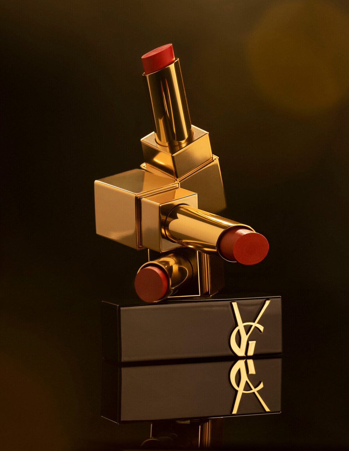 YSL lipsticks in elegant black and gold packaging, neatly displayed in a row, captured by Ylva Erevall.