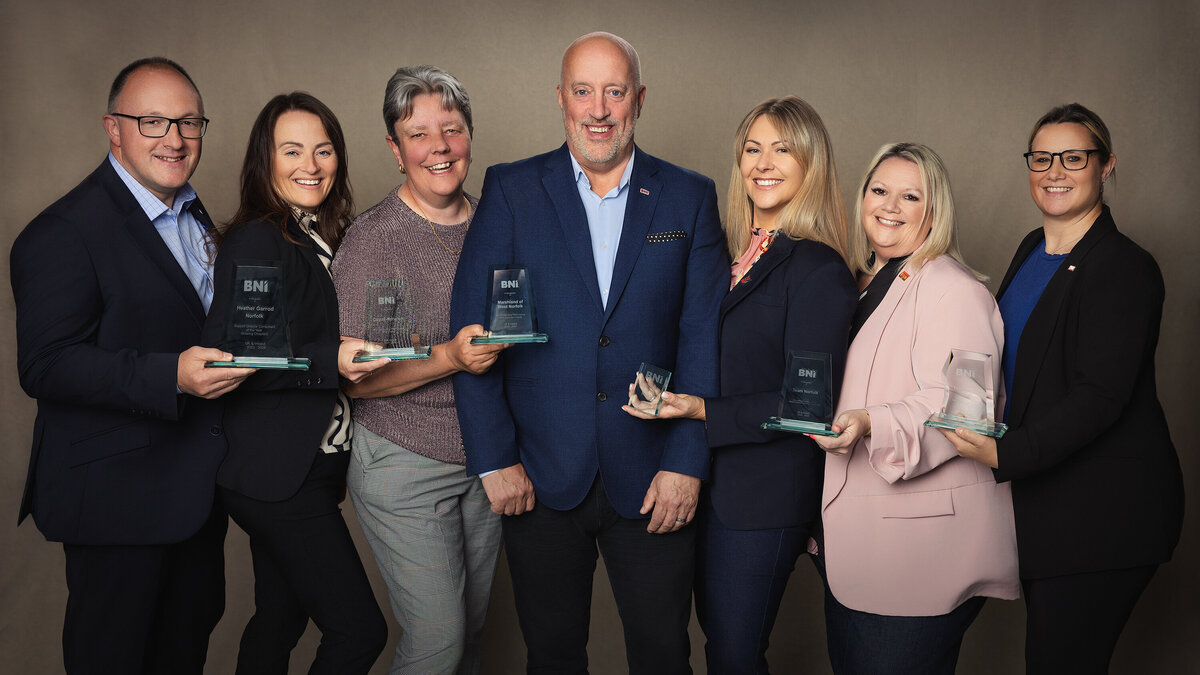 BNI director consultants win awards. Standing with awards on canvas backdrop. Taken by Norwich event photographer Claire Howes. 