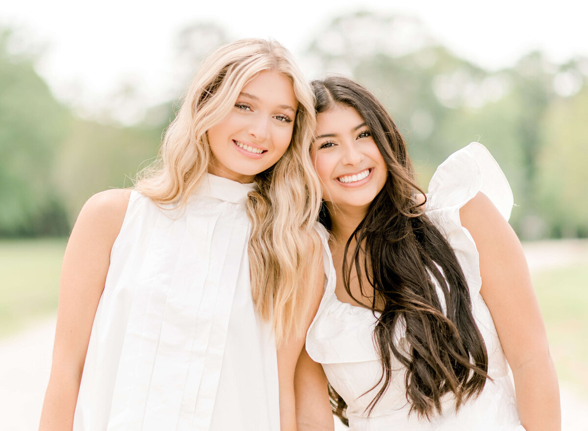 Sweet friends share a side hug during a portrait session with Morgan Leigh Photography.