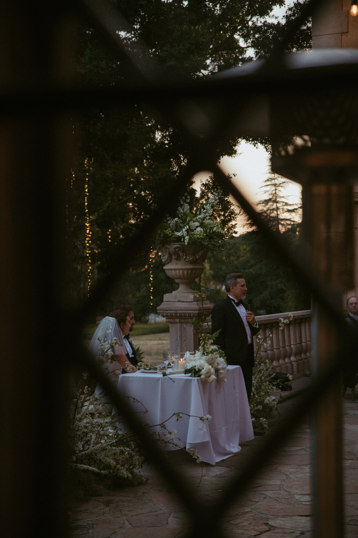 father of the bride giving speech , being framed by window