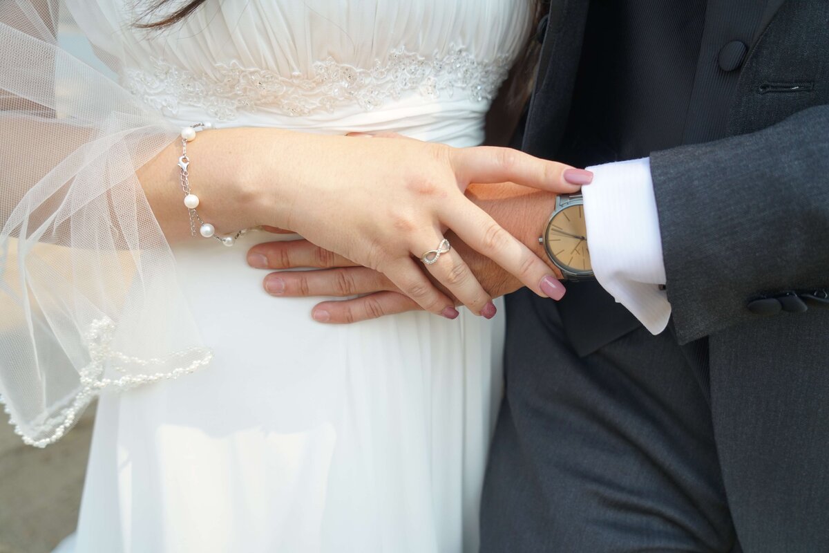 Weddings and Family Portraits in Orange County bride and groom holding hands