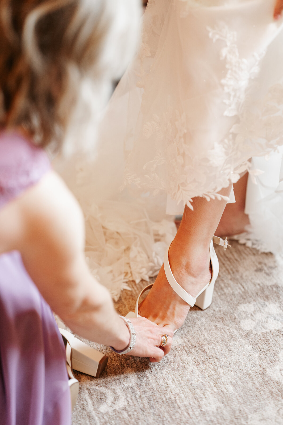 Bride getting ready with her bridesmaids on the morning of her wedding