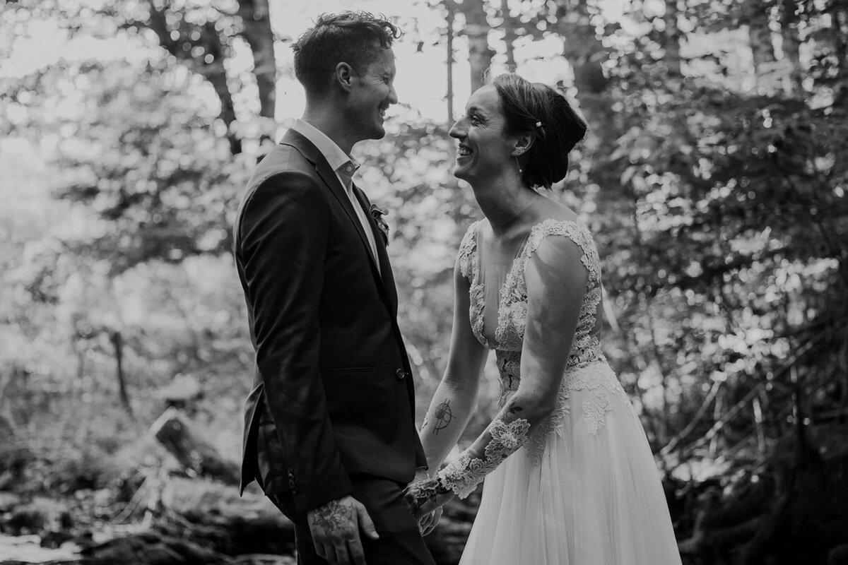 A newlywed couple laughing together