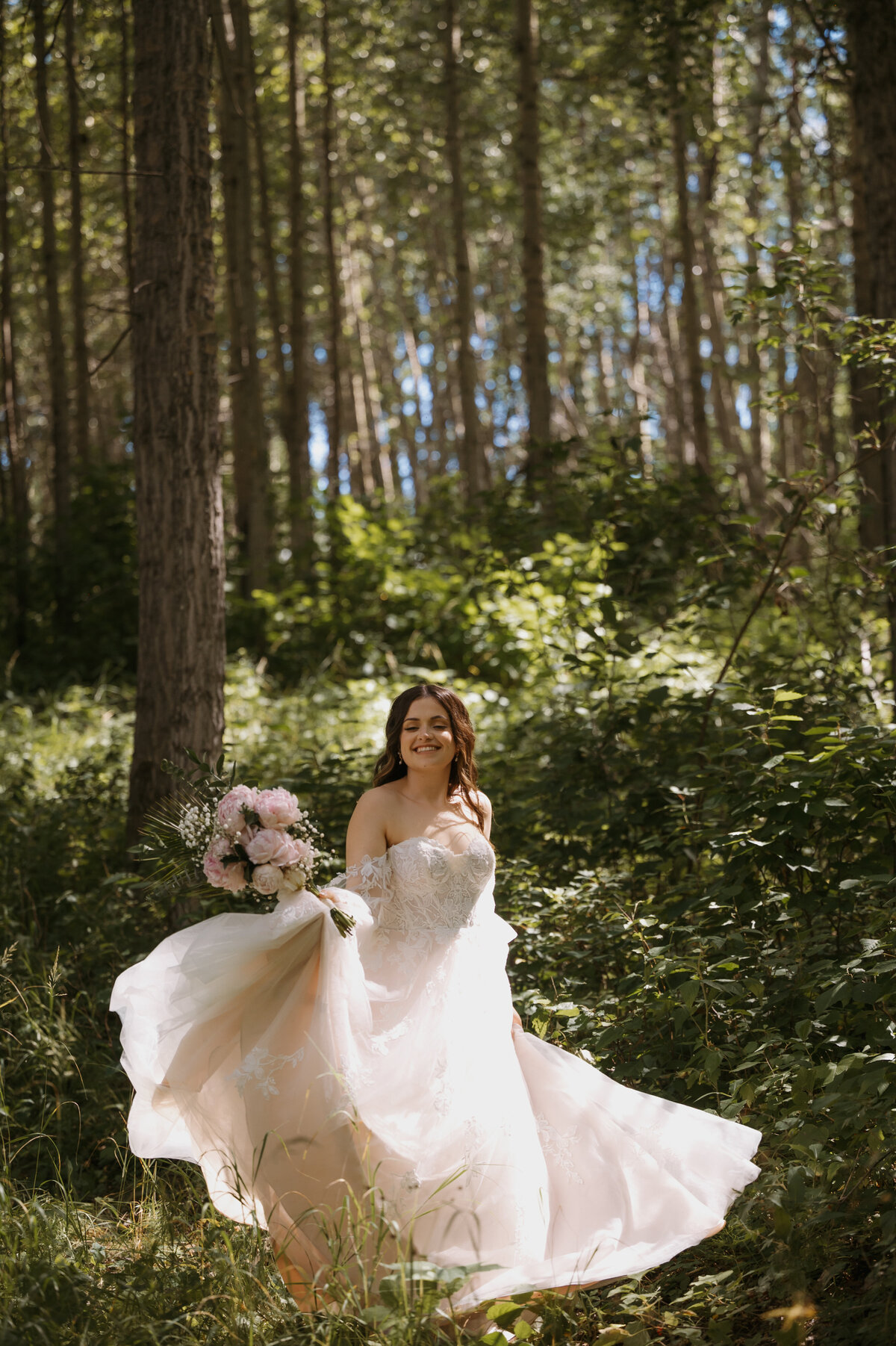 bride running int he trees on her wedding day