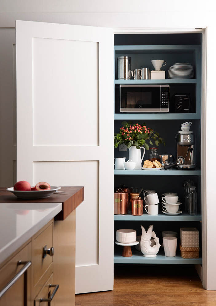 Custom pantry and coffee bar at historic Hingham home makes space for microwave, coffee maker, tea kettle and more, all easily accessible but able to be hidden from the open kitchen.