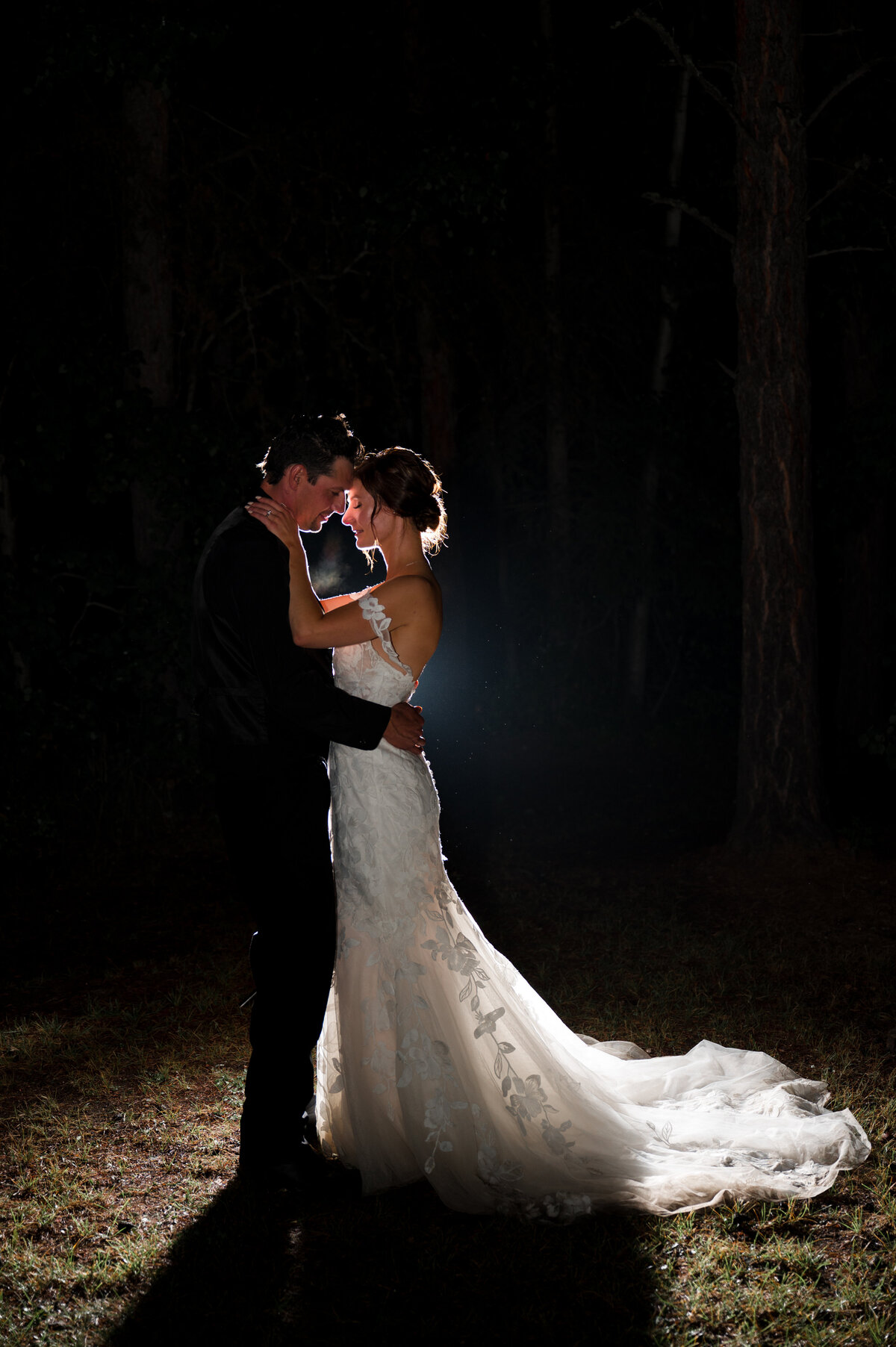 Artistic night photography shot of bride and groom on their wedding