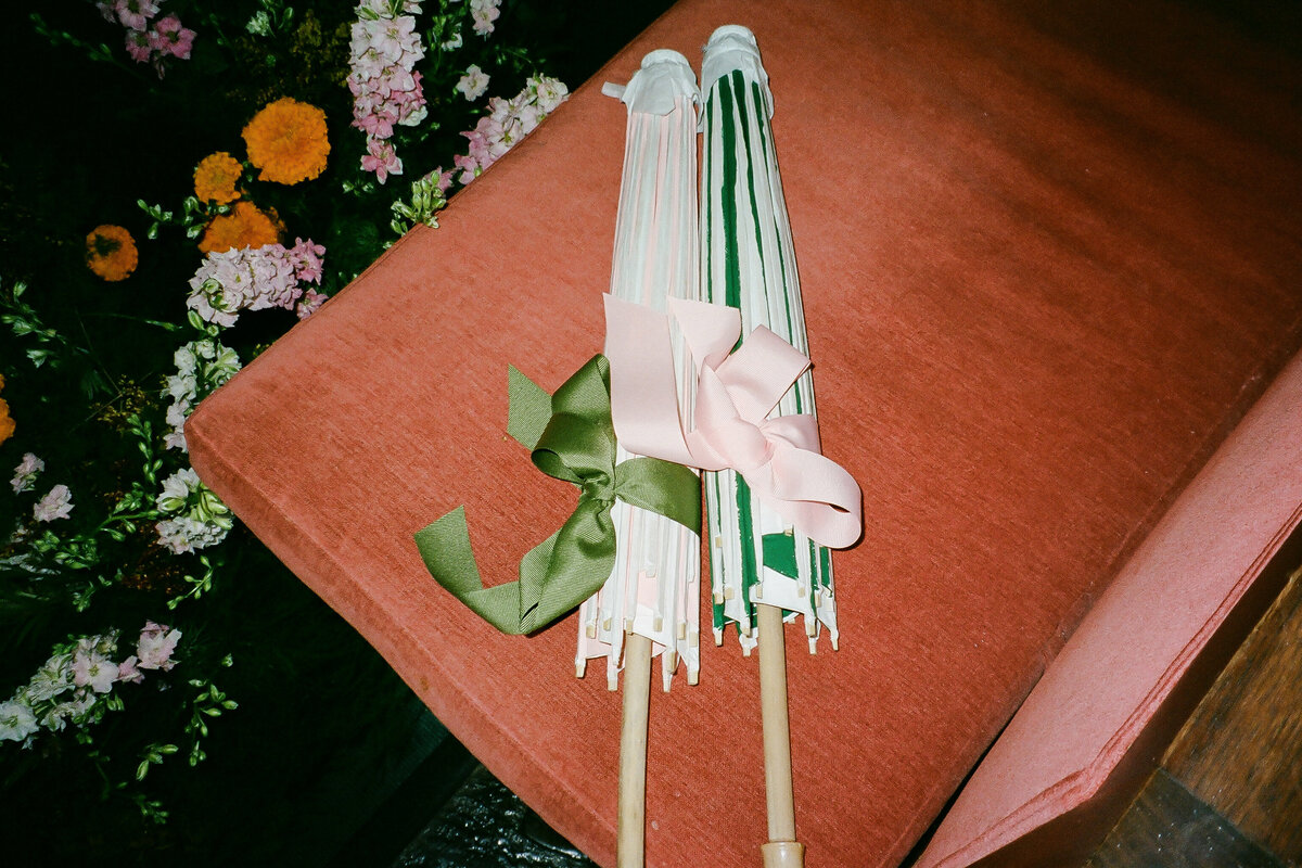 bride and groom umbrellas in Brennan's wedding