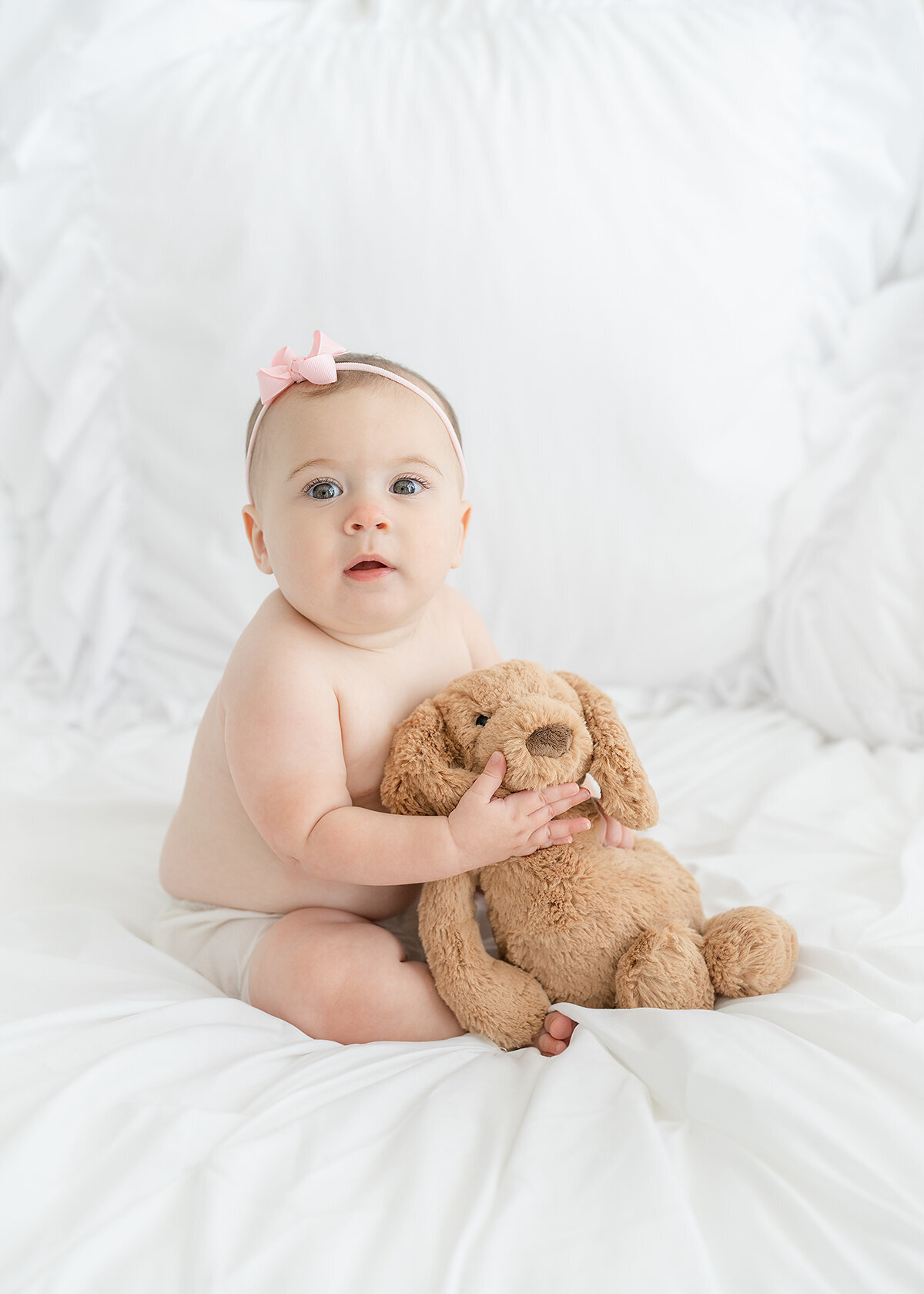 baby girl photographed in a photo studio in brunswick ga with her teddy bear