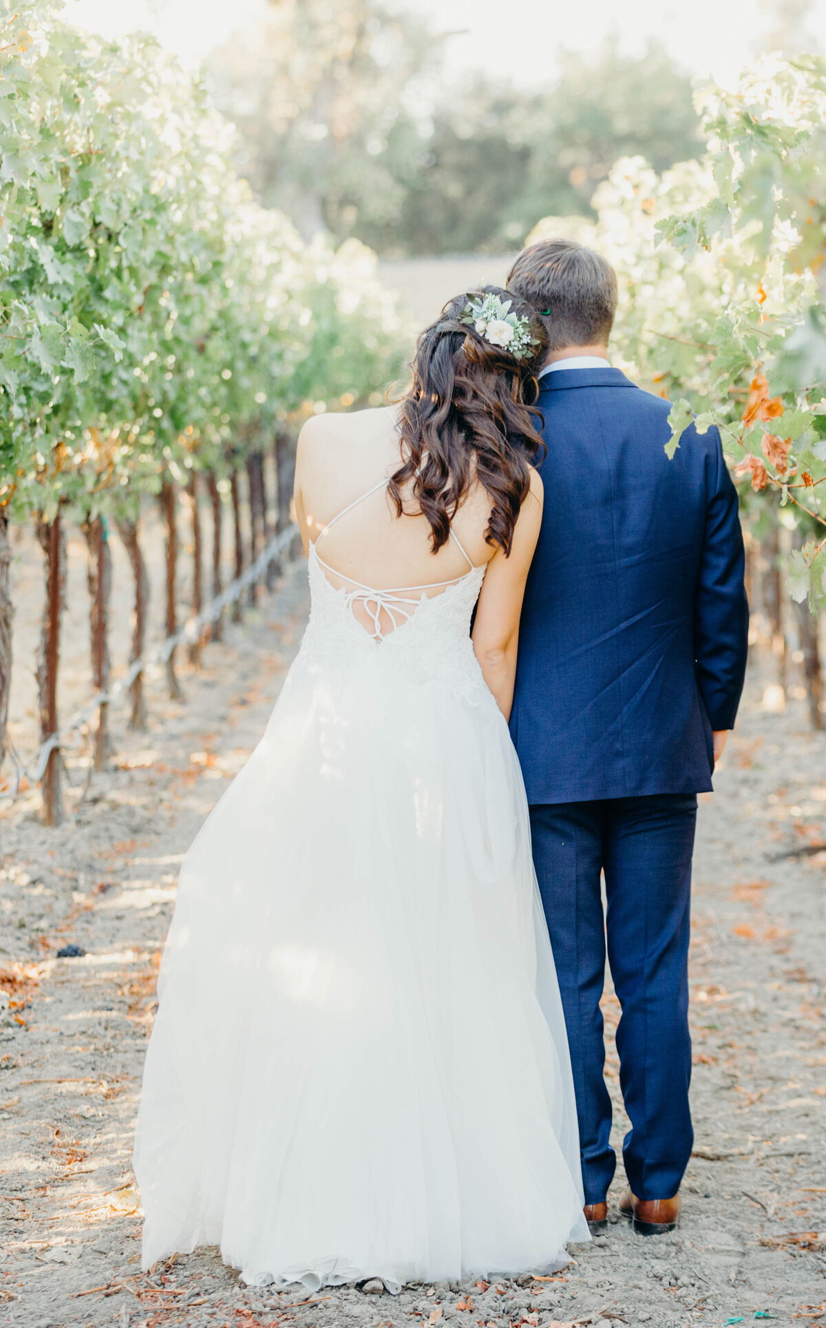 bride and groom standing in the orchard