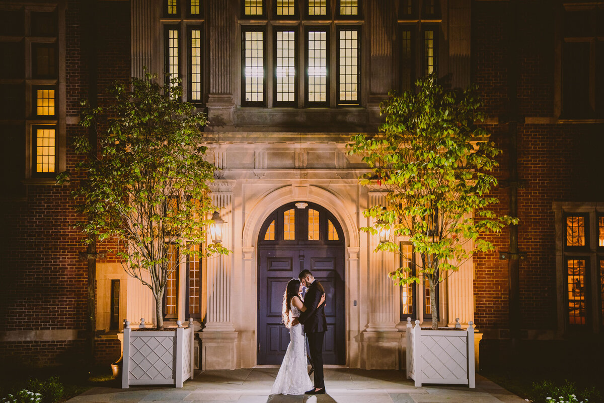 Indian bride and groom outside the natirar mansion at night during the wedding reception