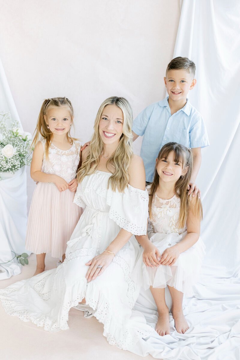 Family sitting and smiling at camera taken by new jersey photographer Ally Kimpton Photography
