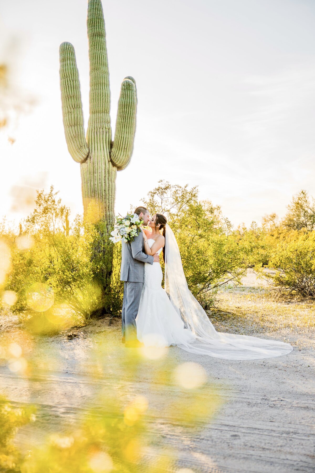 Bride and Groom holding each other in desert cactus golf course wedding in Scottsdale